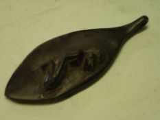 African Art. An ebony pendant of oval form, carved with a kneeling figure. 3 ½