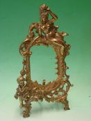 A Gilt Metal Photograph Frame cast and pierced in the rococo taste with female form, putto and