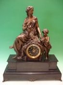 A French Mantle Clock. Black slate and speltar. Surmounted by a classical lady instructing a child