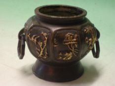 An Oriental Bronze Vase of octagonal form with reserved gilt decoration of birds and prunus raised