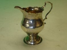 Silver Cream Jug of helmet form with double scroll handle. Crested. London 1768. 3 ¾