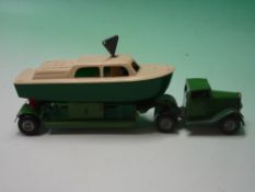 Minic Toys. A clockwork articulated transporter with cabin cruiser. 8 ¾