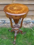 A Victorian Walnut Work Table. The foliate marquetry lid over a shaped frieze with pendant drops (