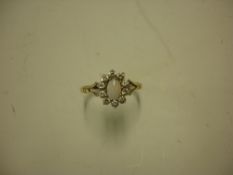 An Opal and Diamond Cluster Ring in 9ct gold