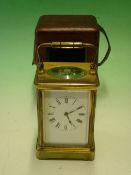 A French Brass Carriage Clock. The enamel mask dial with Roman numerals, the 8 day movement with
