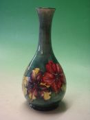 Moorcroft Pottery. A Hibiscus tube-lined baluster vase. Bears paper label. 10 ¼