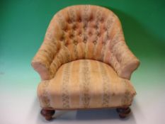A Victorian Child's Tub Armchair with deep-buttoned back, raised on turned walnut feet (minor