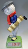 Later Resin Dunlop Caddie figure c/w 3x removable golf clubs on splayed naturalistic base