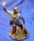 BRONZE FIGURE: Cast bronze figure of an angler netting a fish by Veronese 2004, impressed to rear