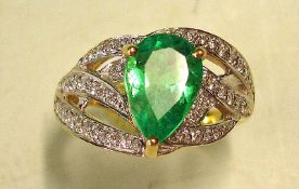 An Emerald and Diamond Ring With a pear shaped Columbian emerald weighing approximately 2cts. In