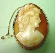 A Shell Cameo Brooch. Carved as a young lady looking left in a gold frame. 2