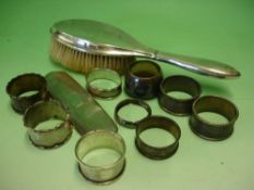 Nine Various Silver Napkin Rings Together with a silver hair brush and a silver brush back. 5.4ozs