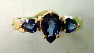 A Ceylon Sapphire Three Stone Ring With pear shaped stones. In gold marked 375. Condition report: