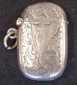 A Silver Vesta Case Of oval form and engraved with foliage and initials to the cartouche, 1 5/8