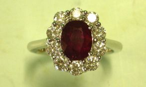 A Ruby and Diamond Cluster ring with a Burmese centre stone weighing approximately 1.67cts and ten