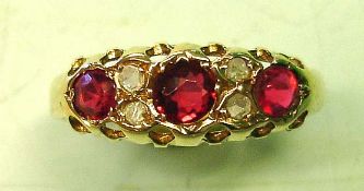 A George V Ring Set with three rubies and four old cut diamonds. In 18ct gold and date marked for