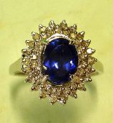 A Tanzanite and Diamond Cluster Ring With oval stone. In white gold marked 14K. Condition report: