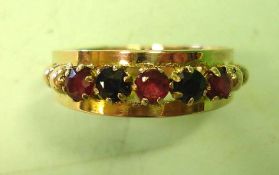 A Sapphire and Ruby Ring Set with three rubies and two sapphires. In gold. Condition report: All