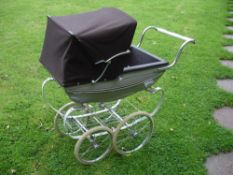 A Silver Cross Doll's Perambulator The grey coach-built body with brown hood on a sprung chassis.