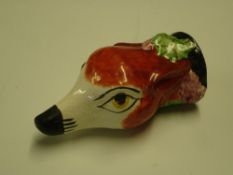 A Staffordshire Stirrup Cup In the form of a fox head decorated with vine fruits. Late 19th or early