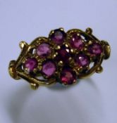 A 9ct Ring With nine pink stones in an openwork setting. 2.4g Condition report: All good
