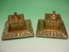 A Pair of Victorian Brass Inkwells Of square form and chased with scrolling foliage. 5 ¼