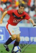 Michael Owen signed colour photograph in Manchester United colours, overall 35.5 x 45.5cm mfg.