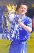 John Terry signed colour photograph in Chelsea colours depicted with Barclays Premier League Trophy,