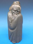 A Lladro figure of a robed Oriental gent