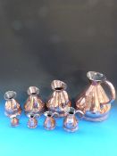 A set of 8 copper measures from 1 gallon