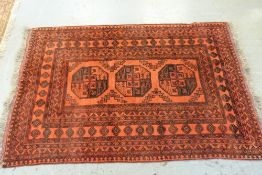A wool rug on a red ground, 220cm x 137c