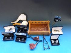 A collection of cufflinks, pipes etc