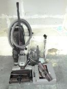 A Kirby vacuum cleaner with a plethora o