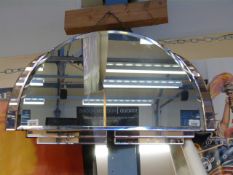 An Art Deco mirror in half-moon shape wi