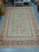 A large red & beige ground Persian carpe