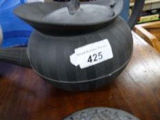 A collection of black basalt teapots in
