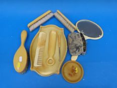 An Art Deco bakelite dressing table set