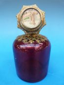 A cranberry glass scent bottle with hand