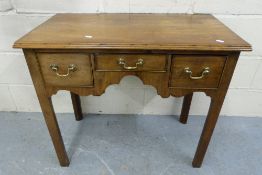 A Georgian mahogany lowboy fitted three