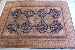 A large blue ground rug with three medal