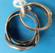 A titanium ring, a white metal Celtic ri