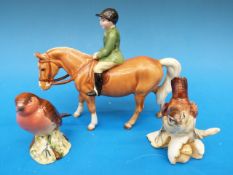 A Beswick boy on a pony together with a