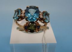 A 14k gold ring set with a central green