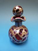 A silver overlaid cranberry glass scent