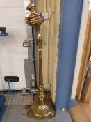 A heavy brass extending lamp raised on t