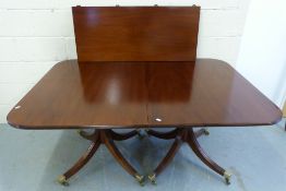 A mahogany twin pedestal dining table wi