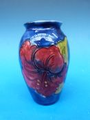 A Moorcroft vase in Hibiscus pattern on