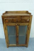 A teak cupboard with drawer to top and c