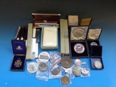 Various coins, pens, knives, book of com