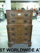 A small walnut chest on chest of two ove